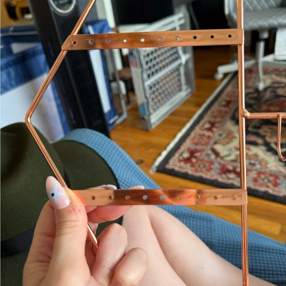 Rose gold jewelry holder with earring holes